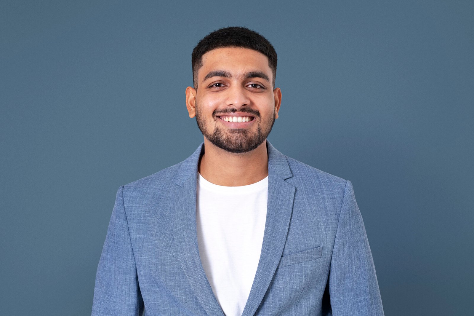 Cheerful Indian businessman smiling closeup portrait for jobs an